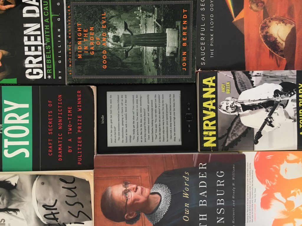a Kindle surrounded by books