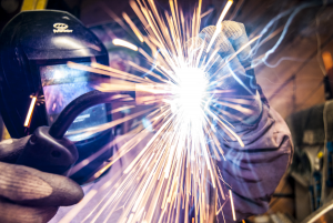 person welding metal and sparks flying