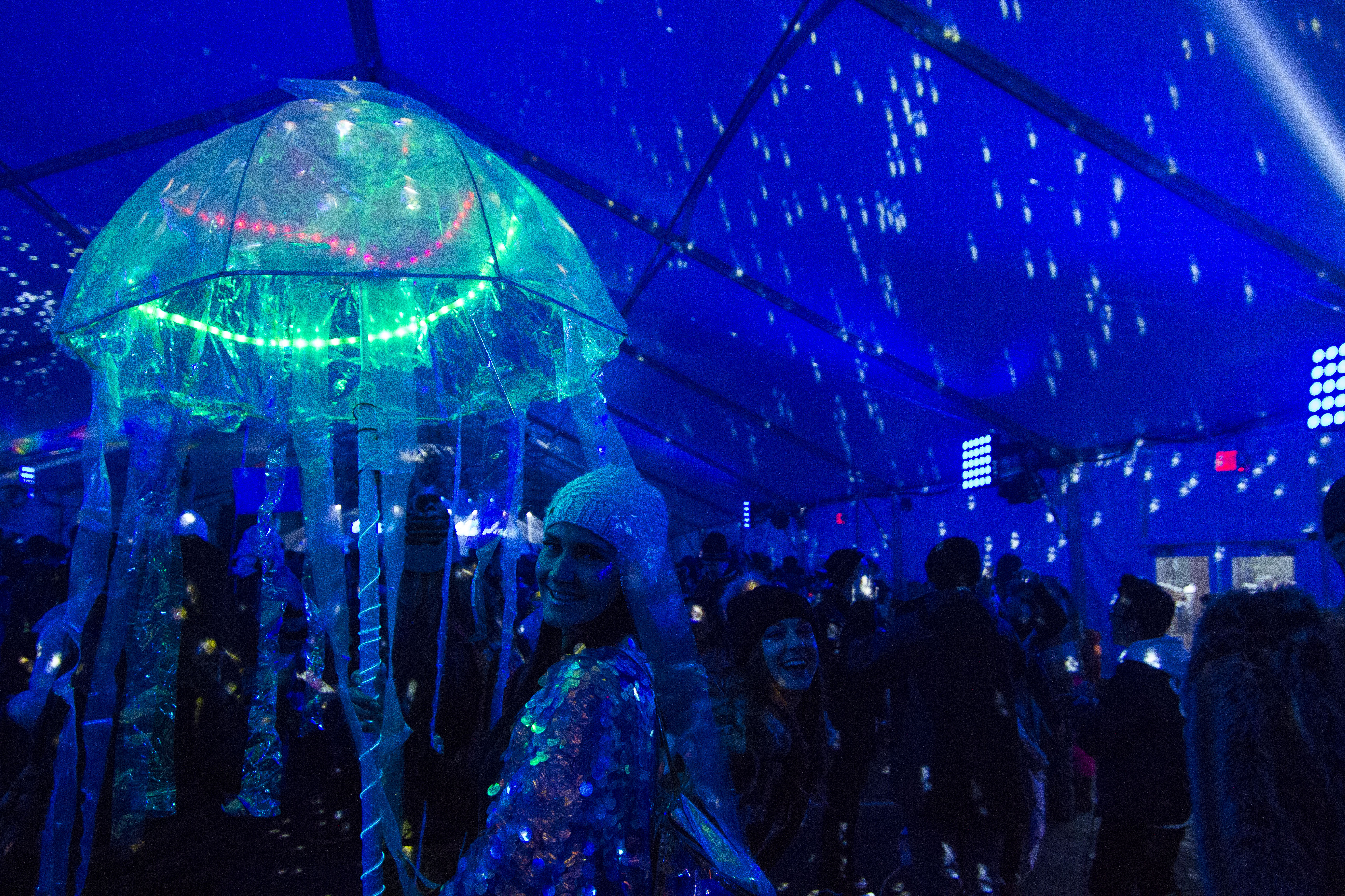 black light concert with a "jellyfish" umbrella